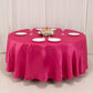 Fuchsia round satin tablecloth set for elegant dining occasions.