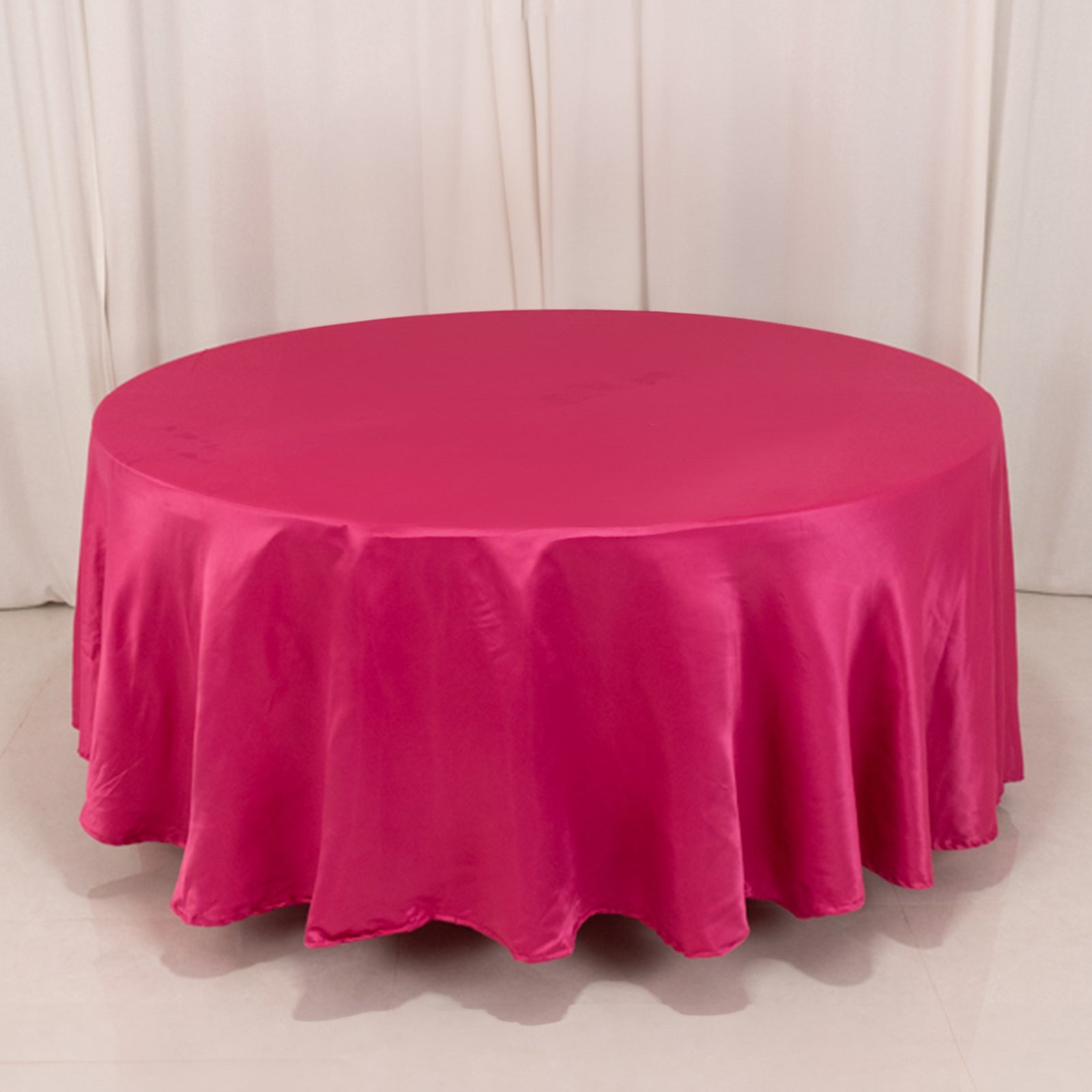 Fuchsia satin round tablecloth for elegant table settings.