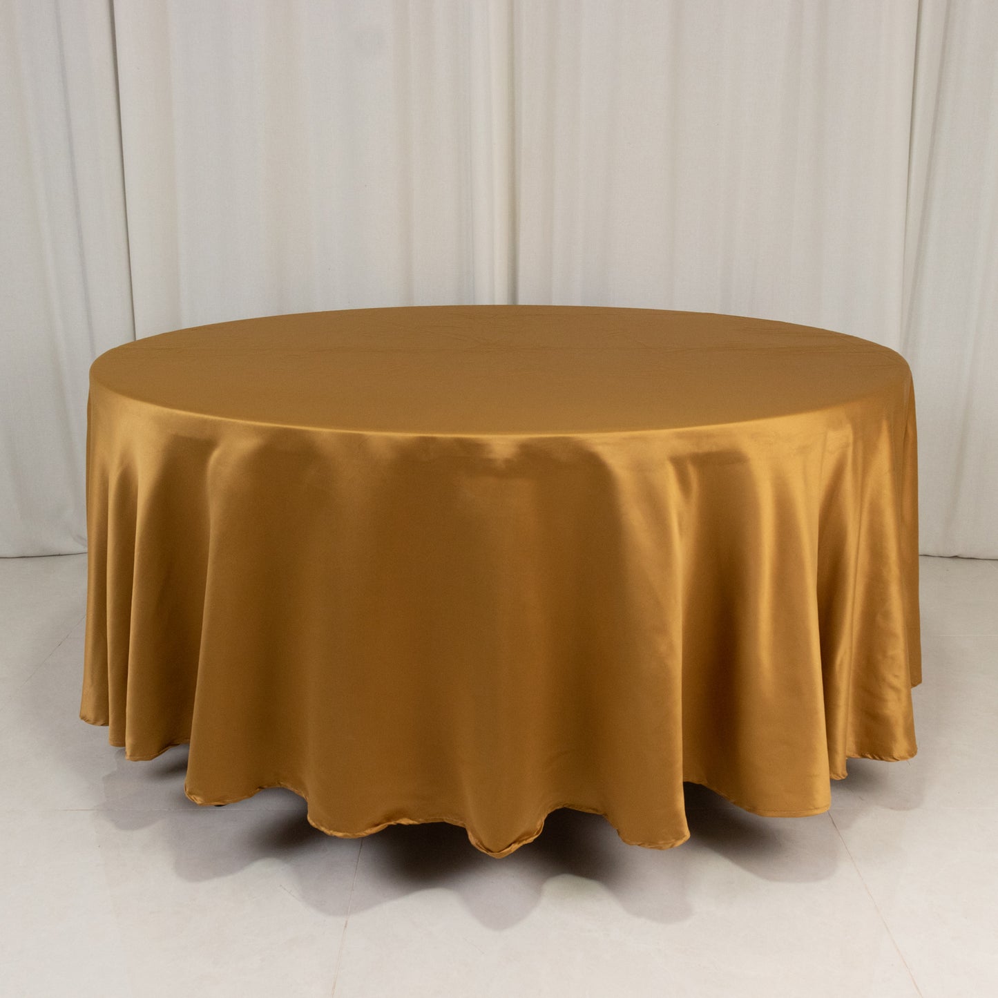 Gold round satin tablecloth, 108 inches in diameter.