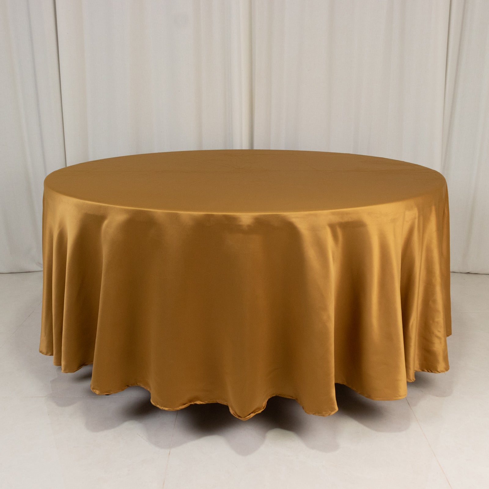 Gold round satin tablecloth, 108 inches in diameter.