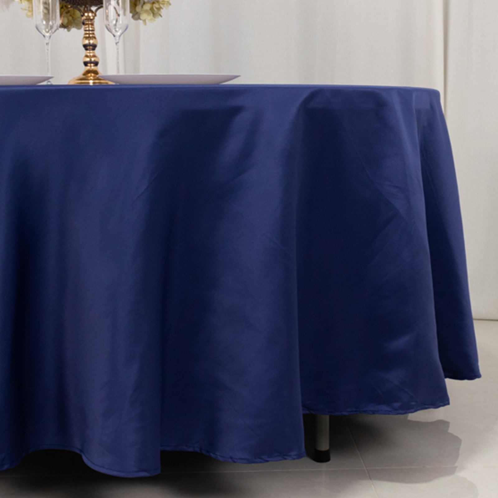 Navy blue round tablecloth draping elegantly over a table.