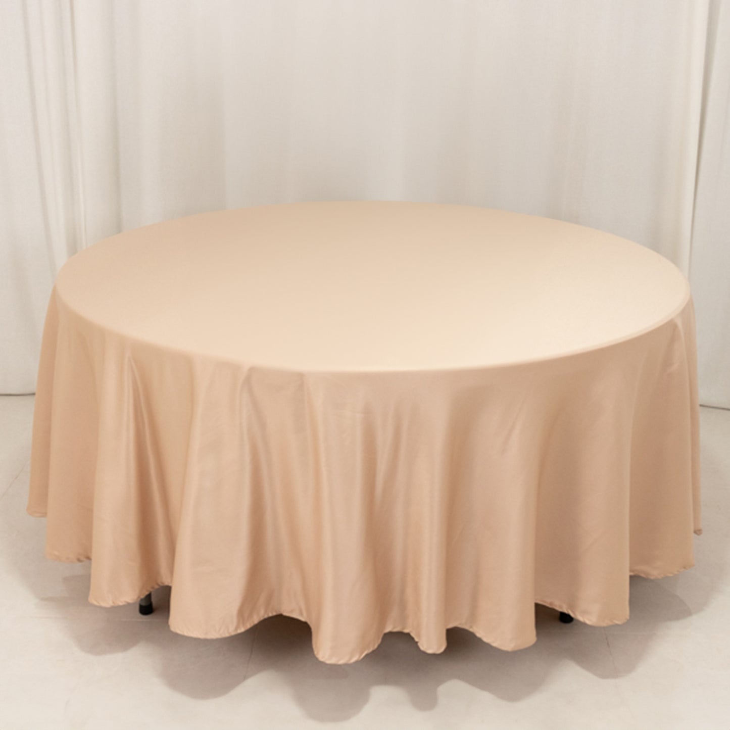 Nude satin round tablecloth for elegant dining settings.