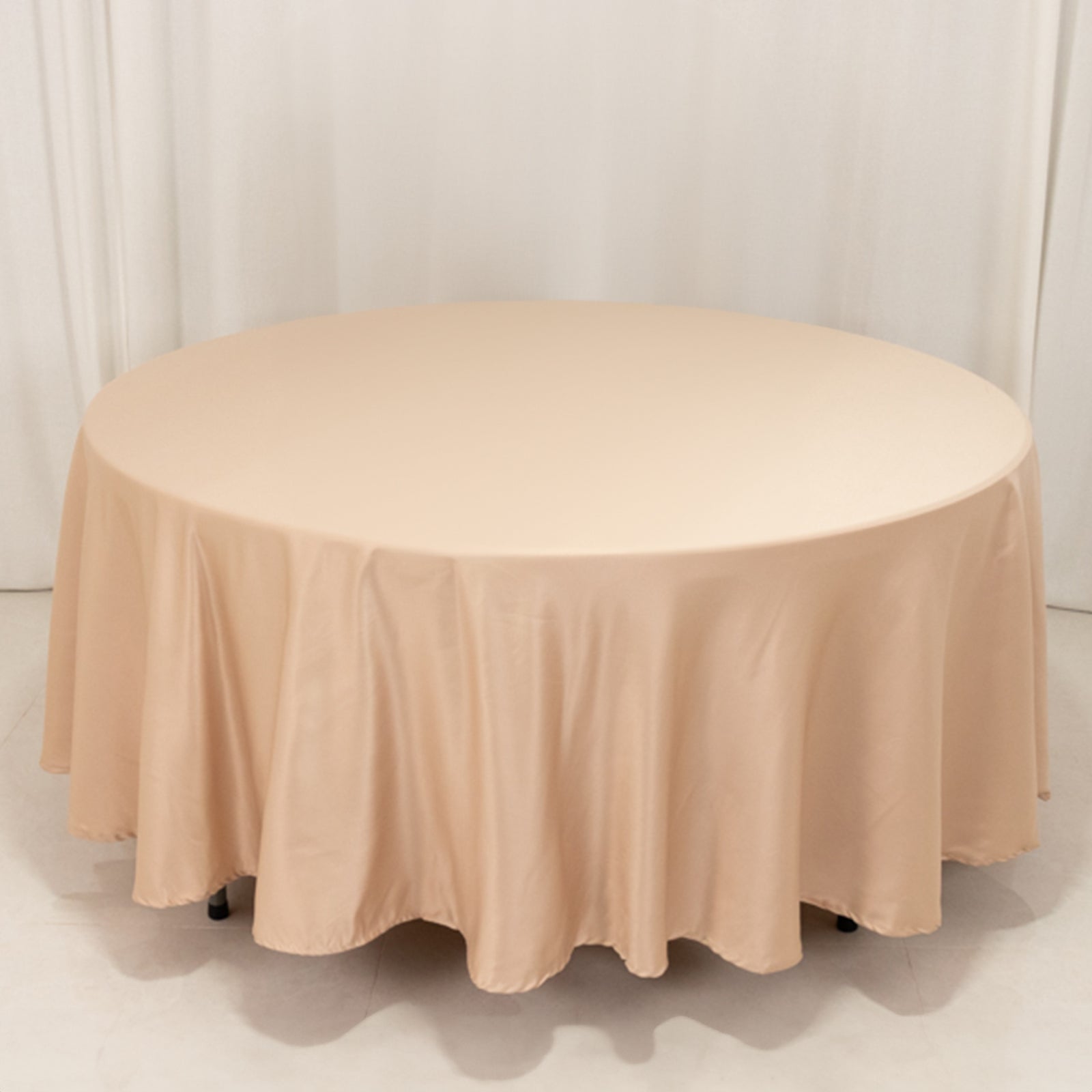 Nude satin round tablecloth for elegant dining settings.