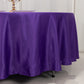 Purple satin round tablecloth on a dining table.
