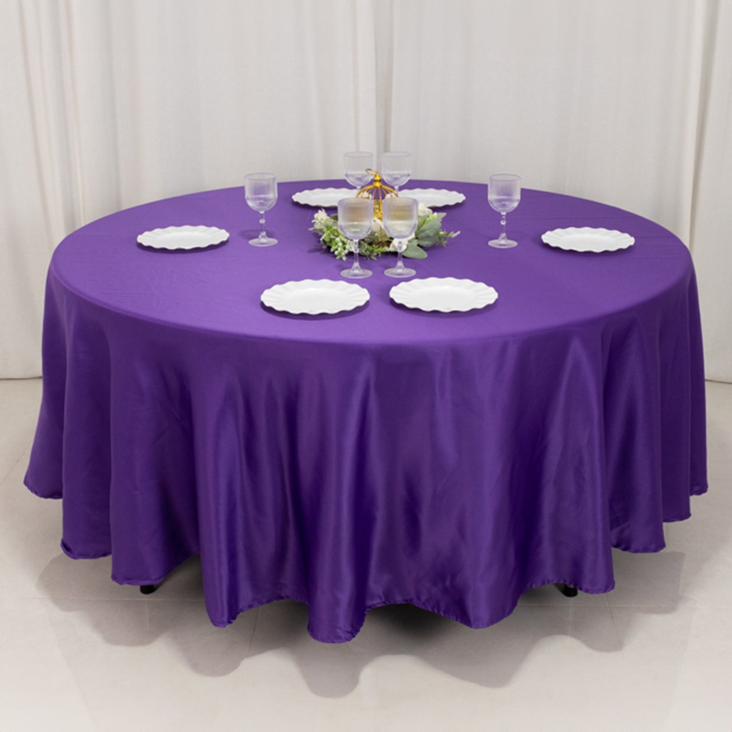 Purple satin round tablecloth for elegant dining setups.