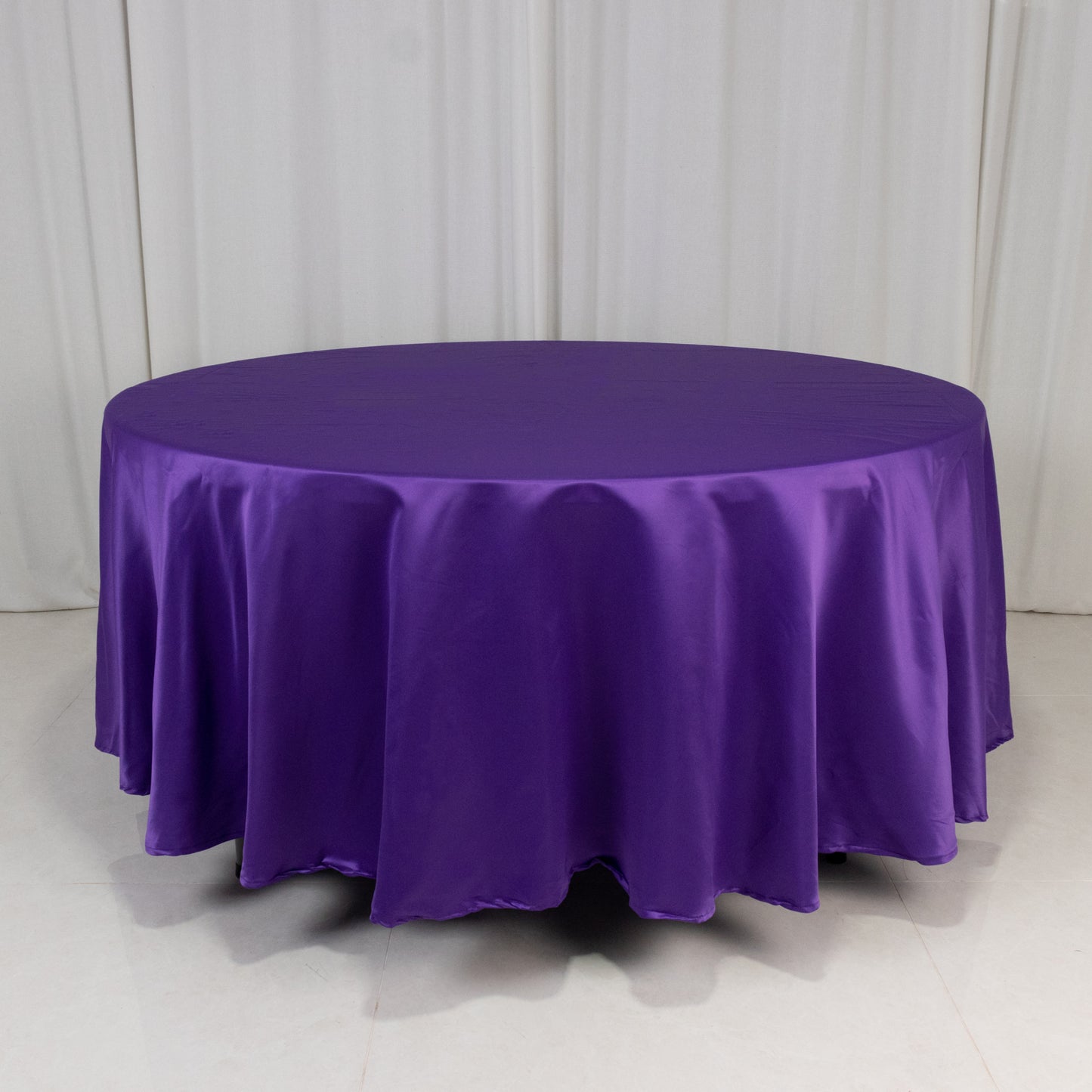 Purple satin round tablecloth on a white background.