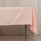 Blush satin rectangle tablecloth on a dining table.
