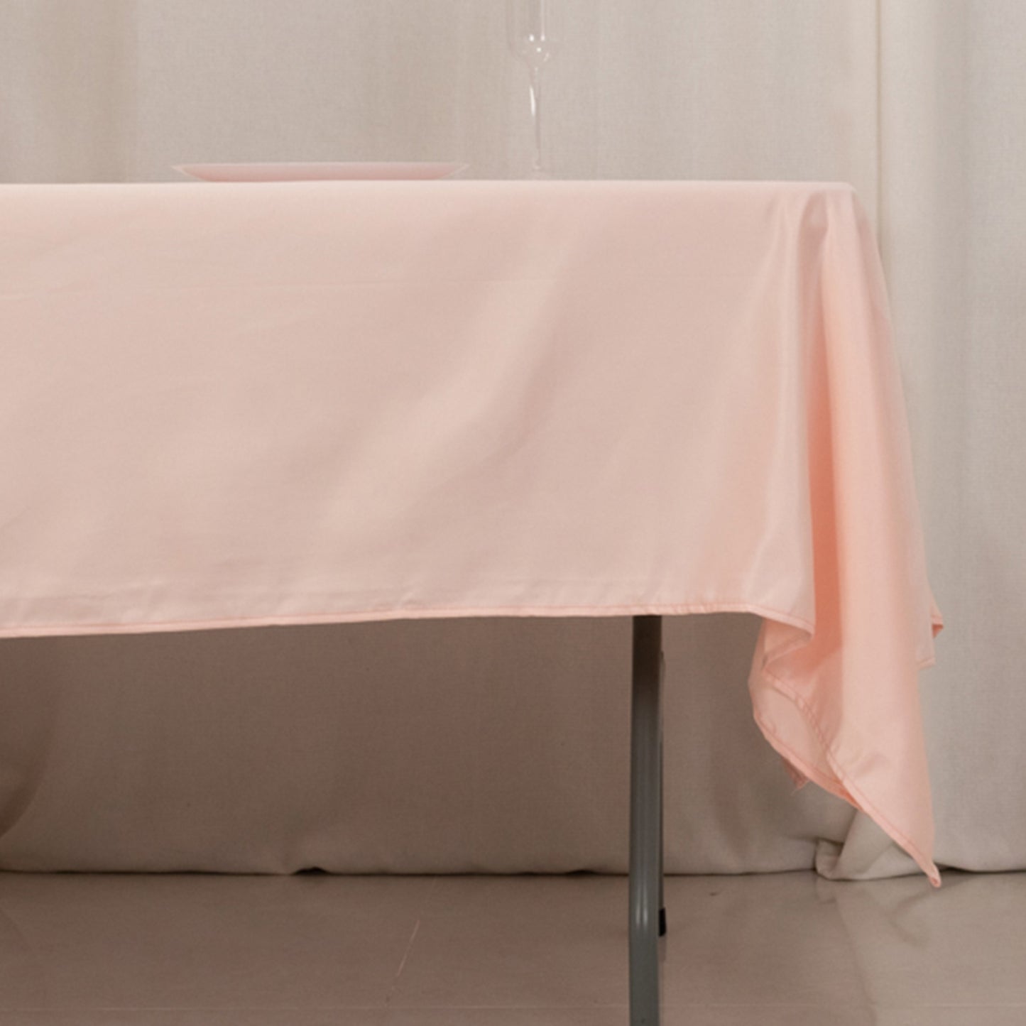 Blush satin rectangle tablecloth on a dining table.