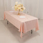 Blush satin rectangle tablecloth on a dining table with floral centerpiece.