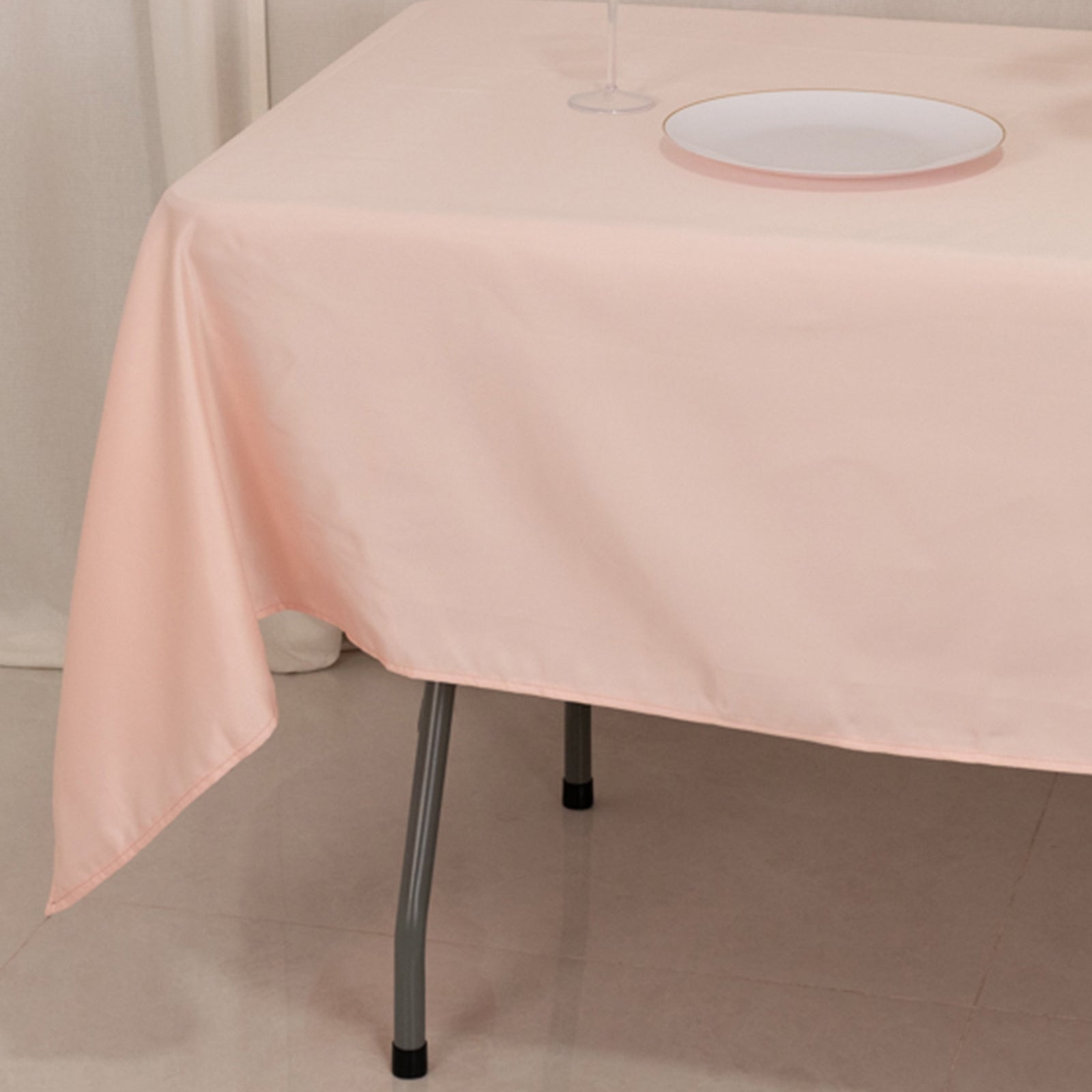 Blush satin rectangle tablecloth on a dining table.