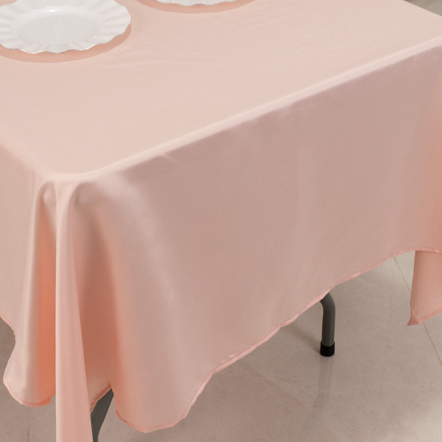 Blush Lamour Satin Rectangle Tablecloth on a dining table.