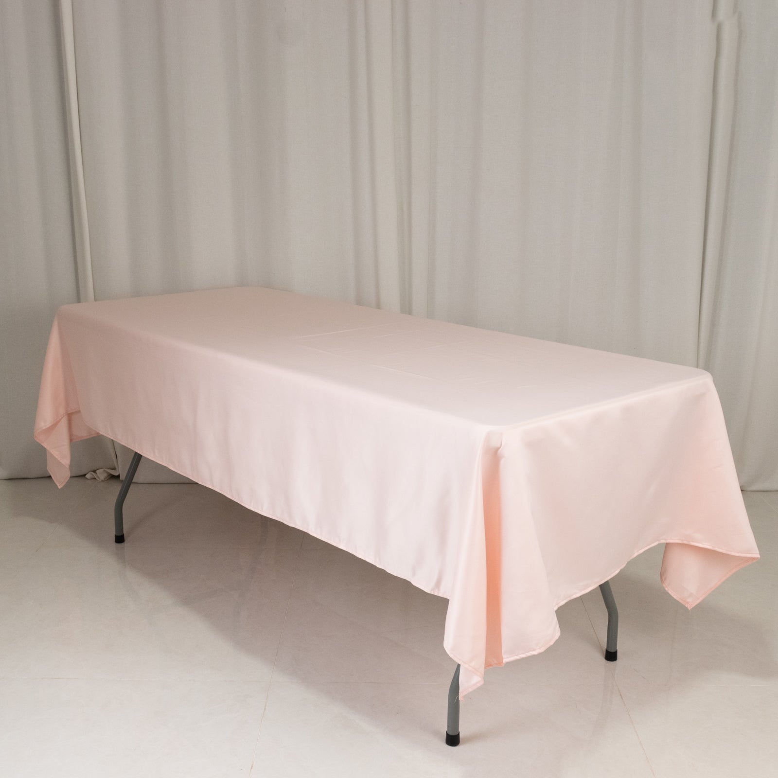 Blush satin rectangle tablecloth, 60"x102", elegant and smooth finish.