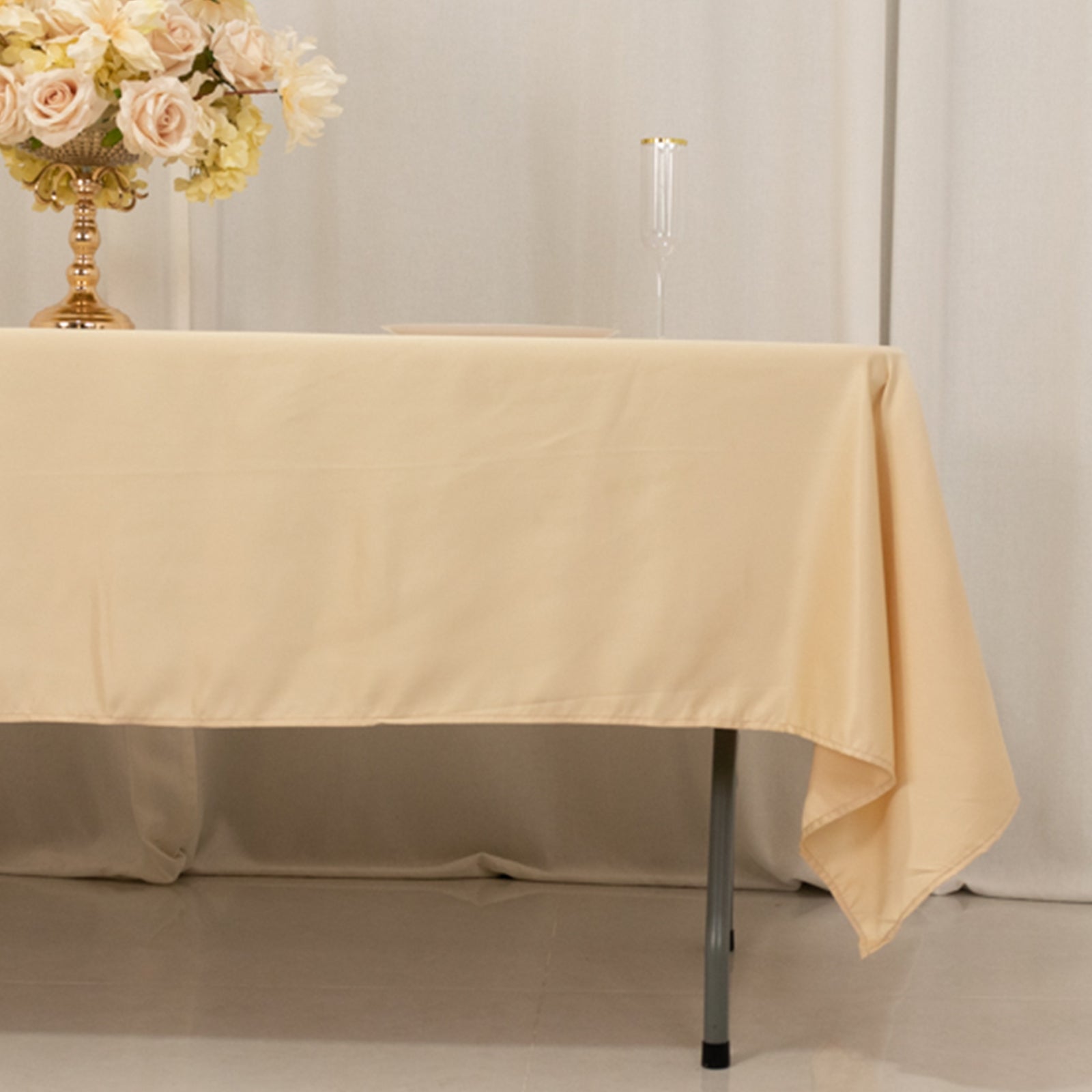 Beige satin tablecloth perfect for elegant dining setups.