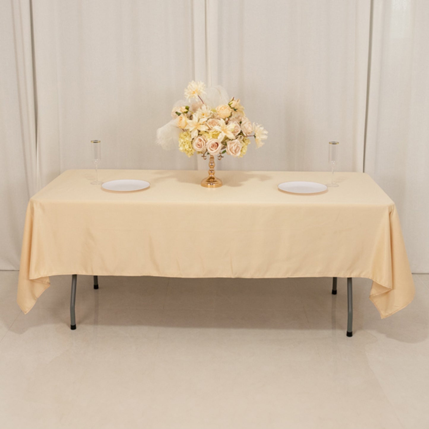 Beige satin rectangle tablecloth on a table with floral centerpiece.