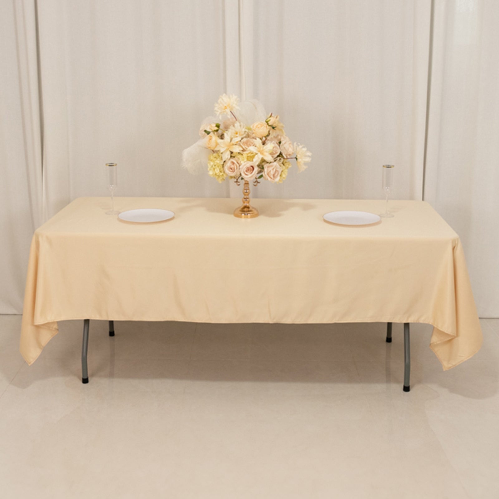 Beige satin rectangle tablecloth on a table with floral centerpiece.