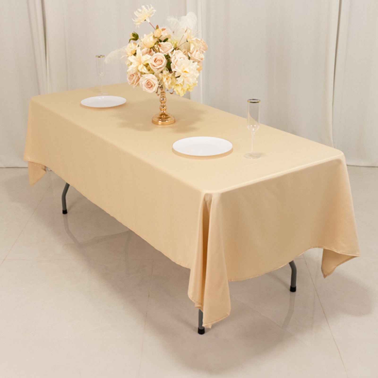 Beige Lamour satin rectangle tablecloth on a dining table.