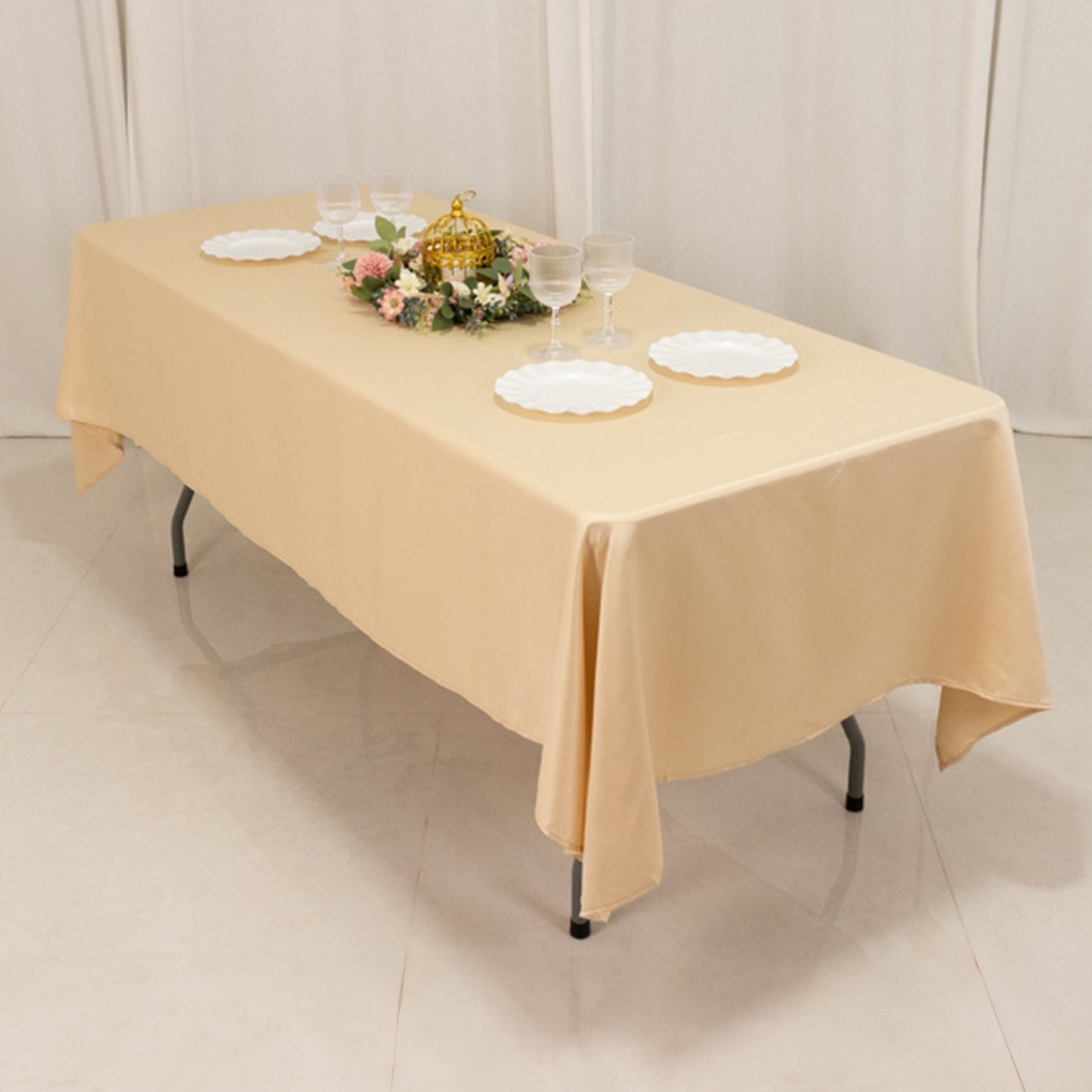 beige satin rectangle tablecloth on a table with decorative items