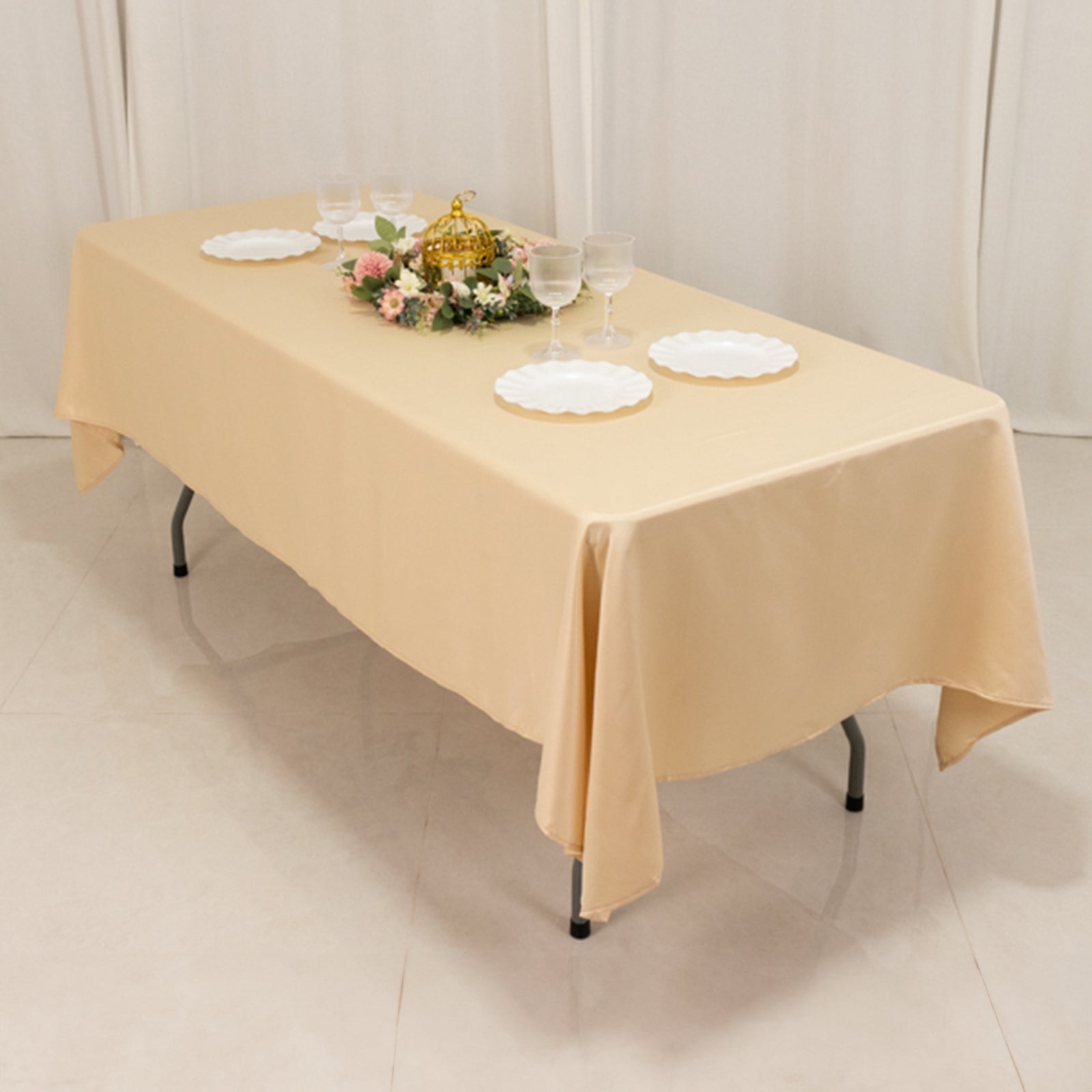 beige satin rectangle tablecloth on a table with decorative items
