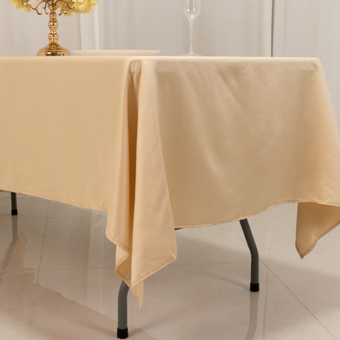 Beige satin rectangle tablecloth for elegant dining settings.