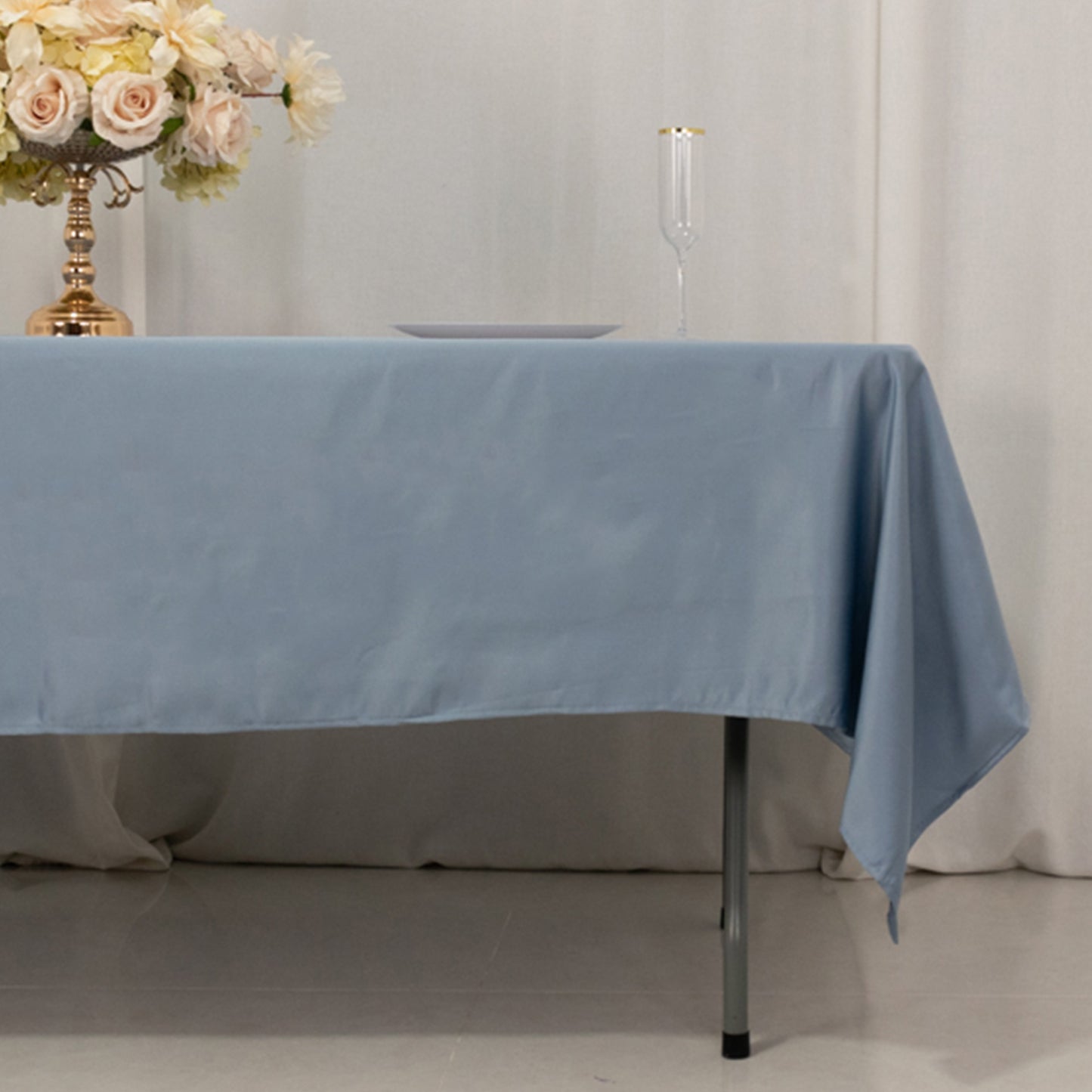 Dusty blue satin rectangle tablecloth on a table setting.