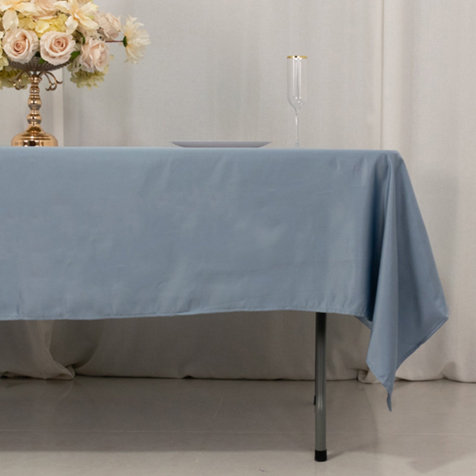 Dusty blue satin rectangle tablecloth on a table setting.