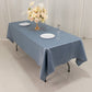 Dusty blue satin rectangle tablecloth on a dining table.
