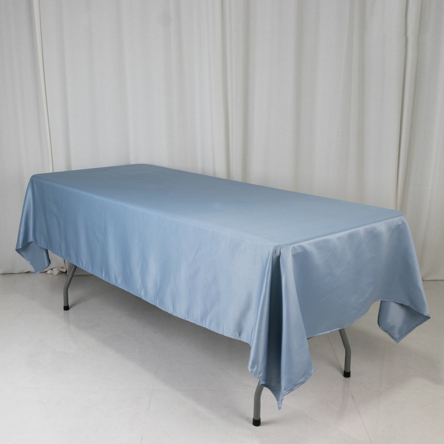 Dusty blue satin rectangle tablecloth on a table.