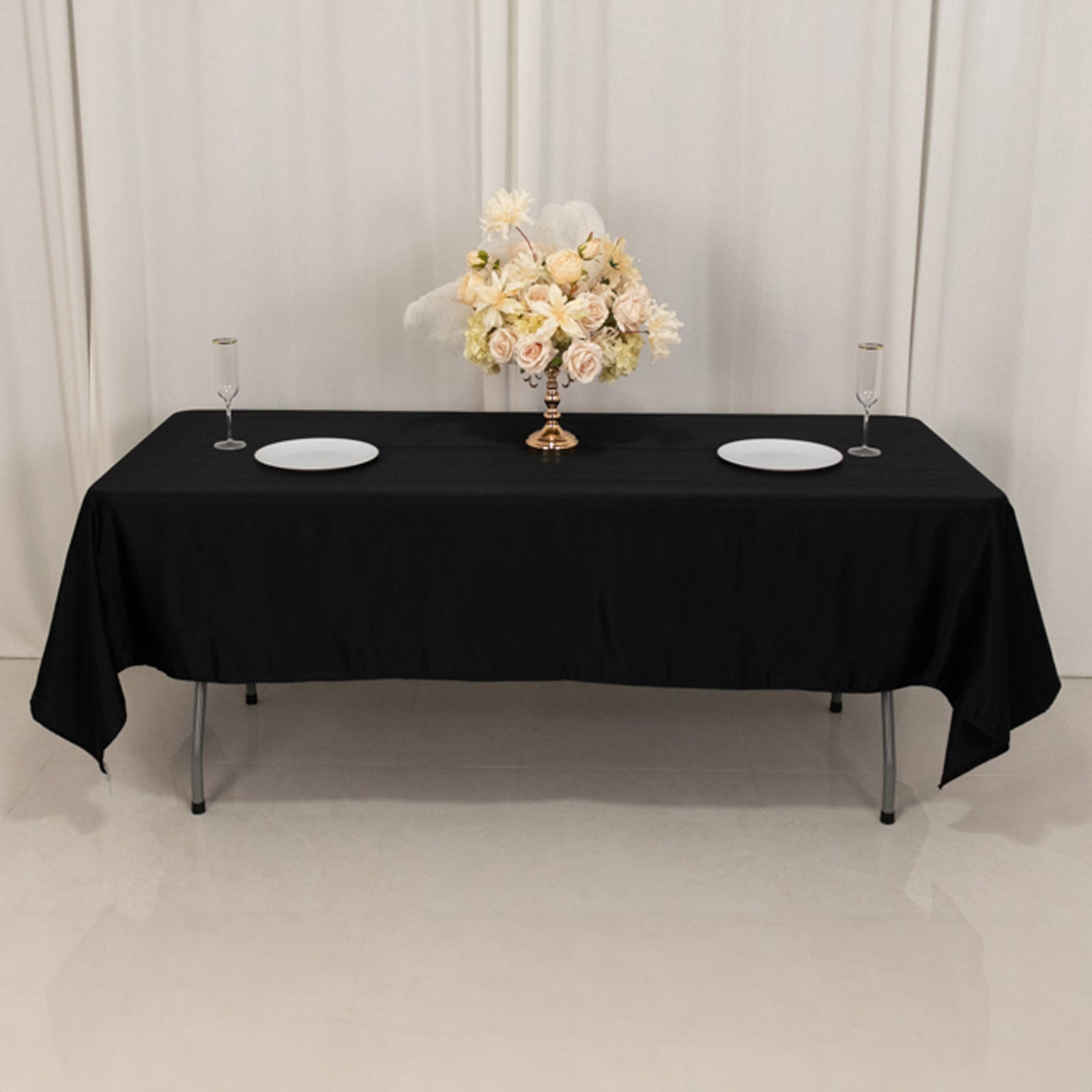 Black Lamour satin rectangle tablecloth on a table with floral centerpiece.