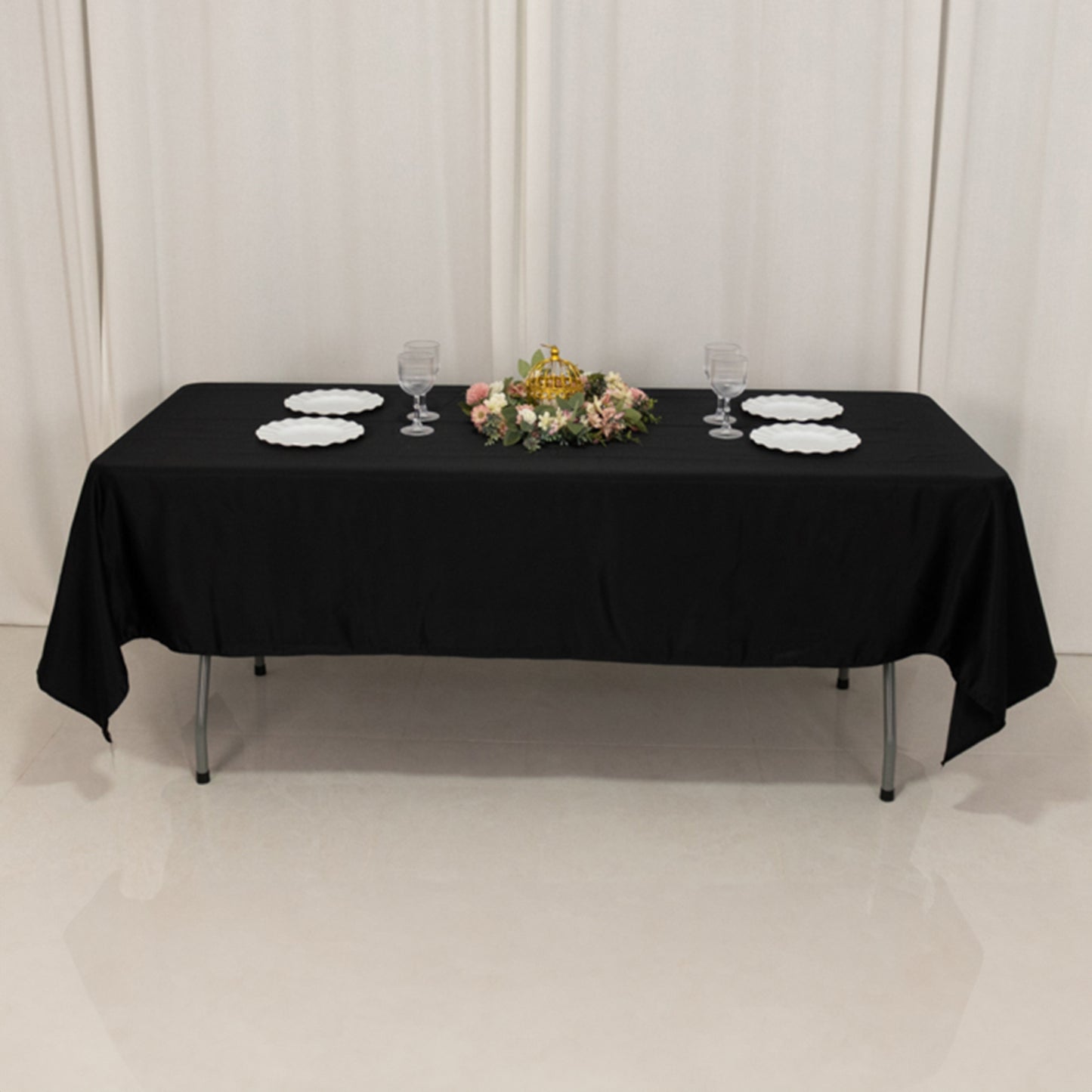 Black Lamour satin rectangle tablecloth on a table with floral centerpiece.