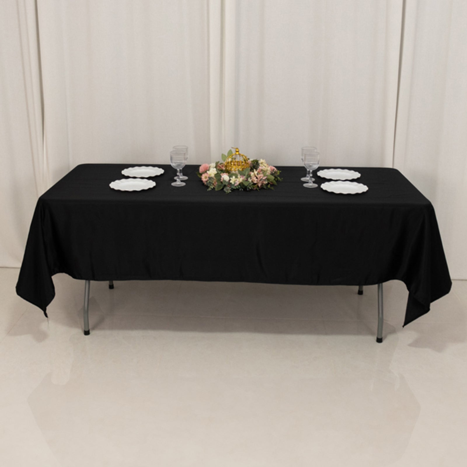 Black Lamour satin rectangle tablecloth on a table with floral centerpiece.
