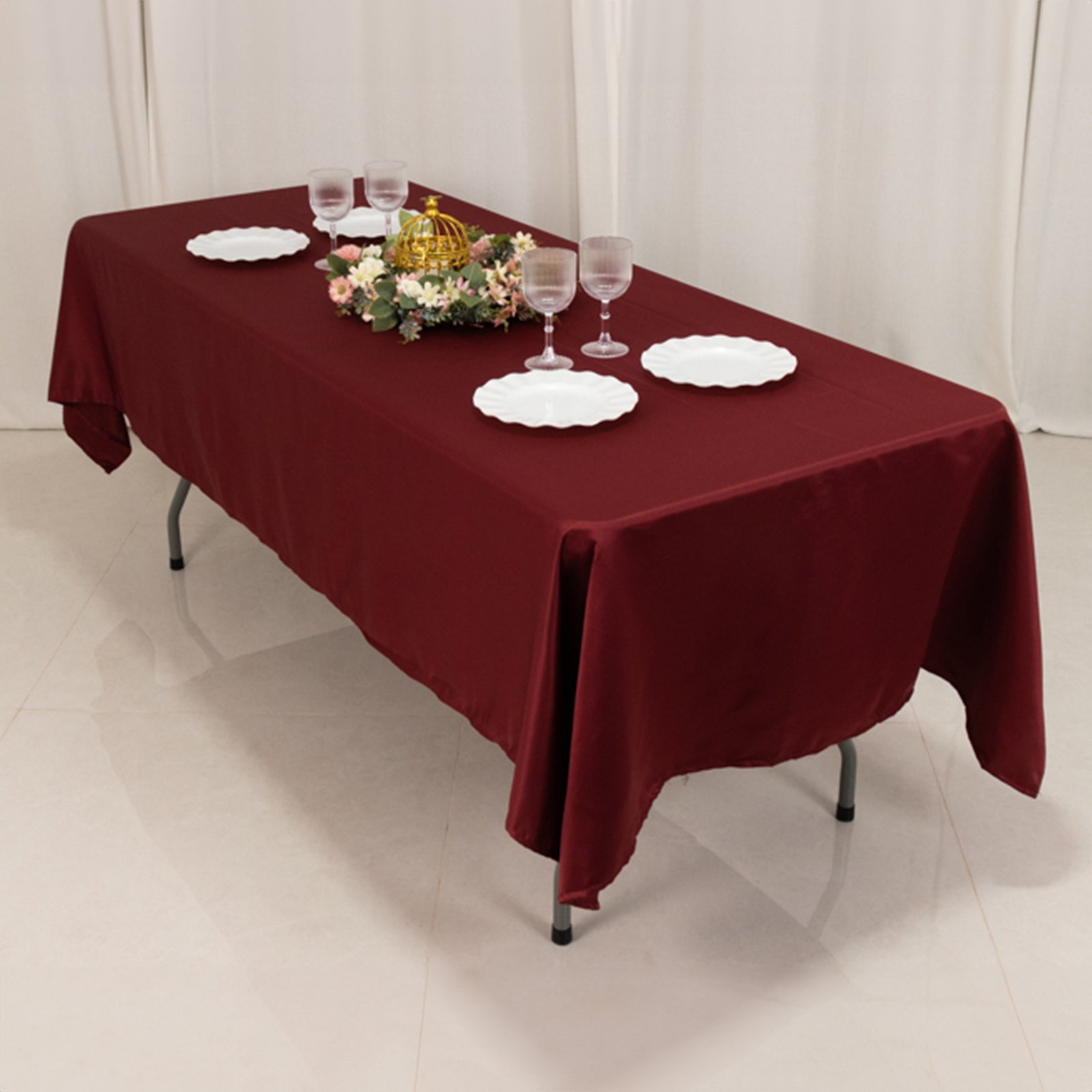 Burgundy Lamour satin rectangle tablecloth on a dining table.