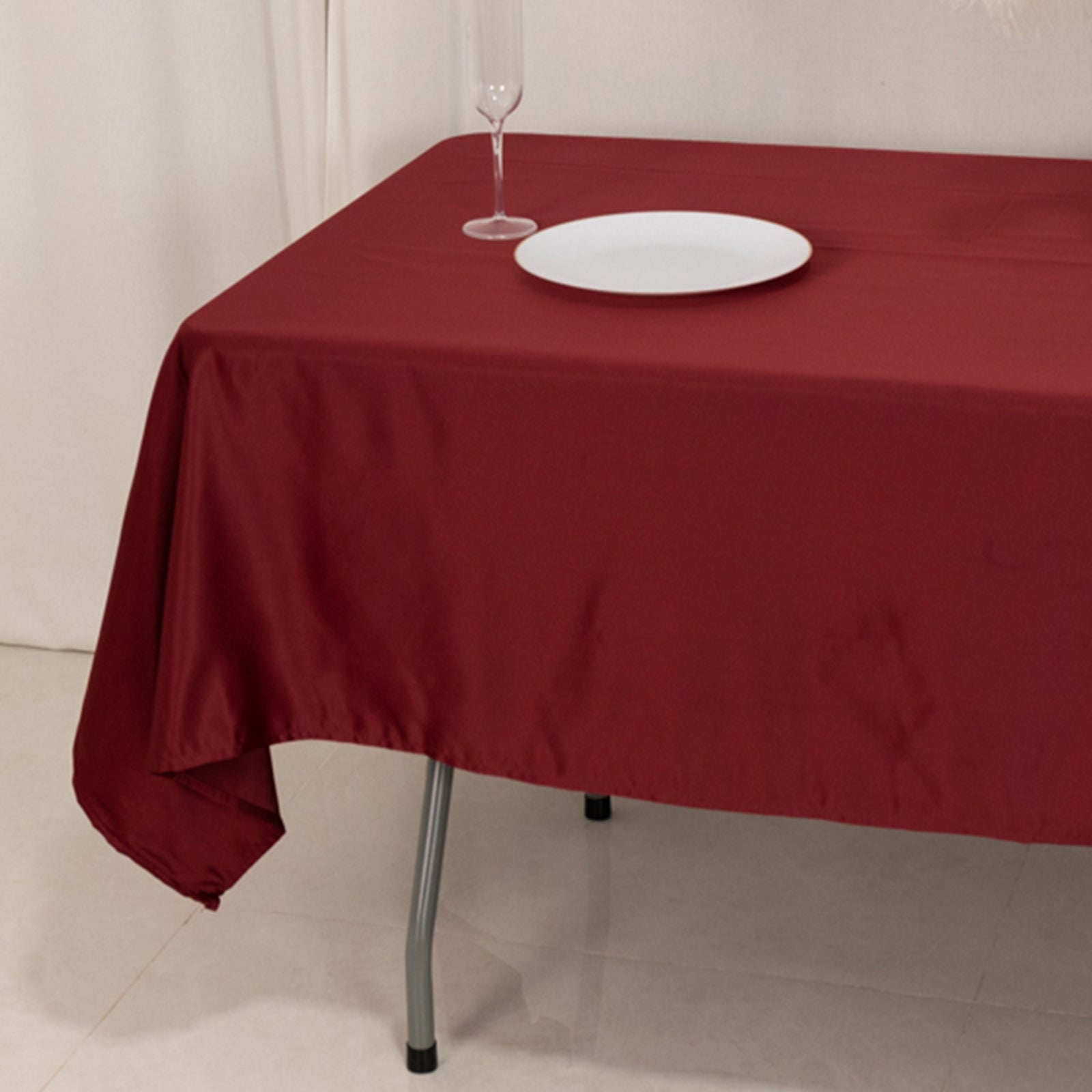 Burgundy satin rectangle tablecloth on a table.