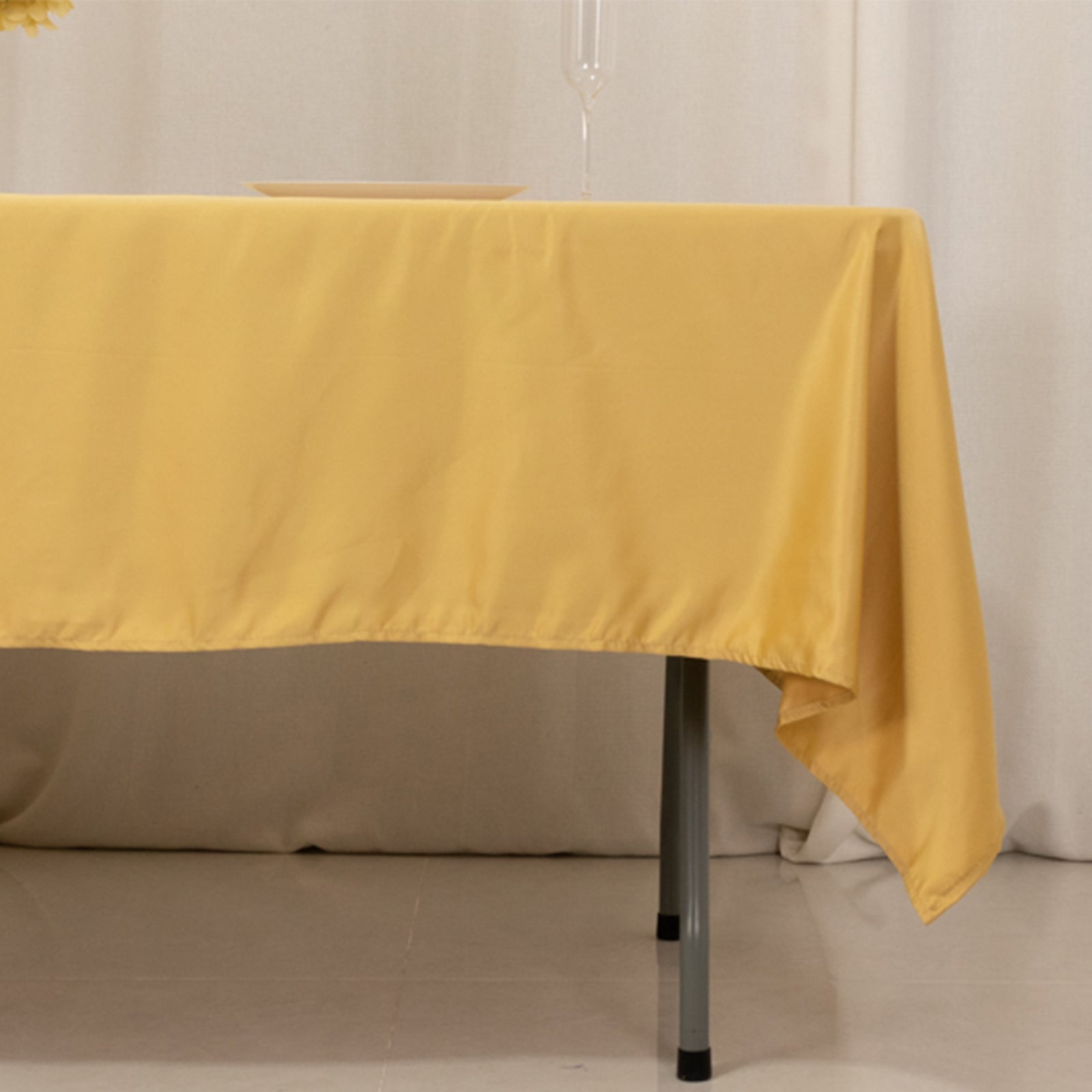 Champagne satin rectangle tablecloth on a table.