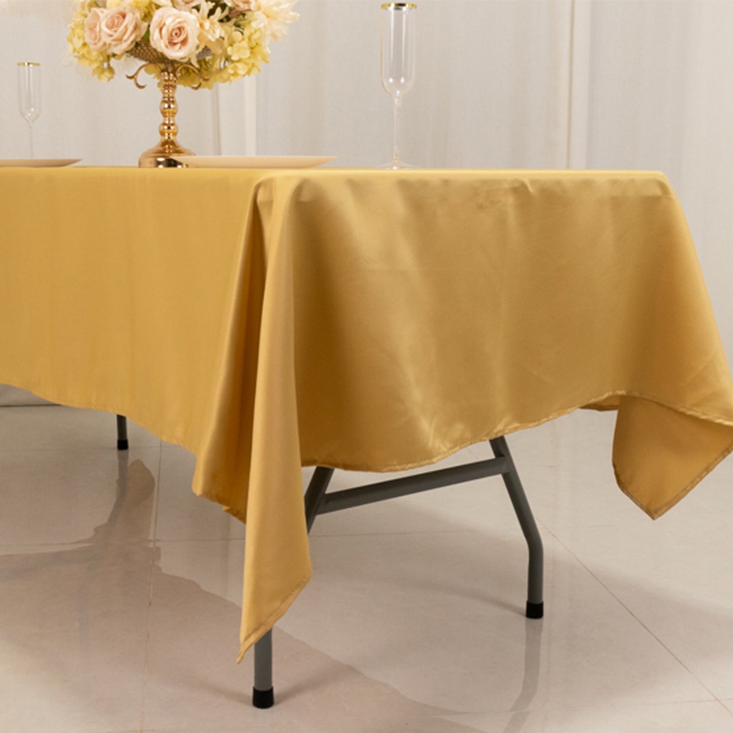 Champagne satin rectangle tablecloth on a dining table.