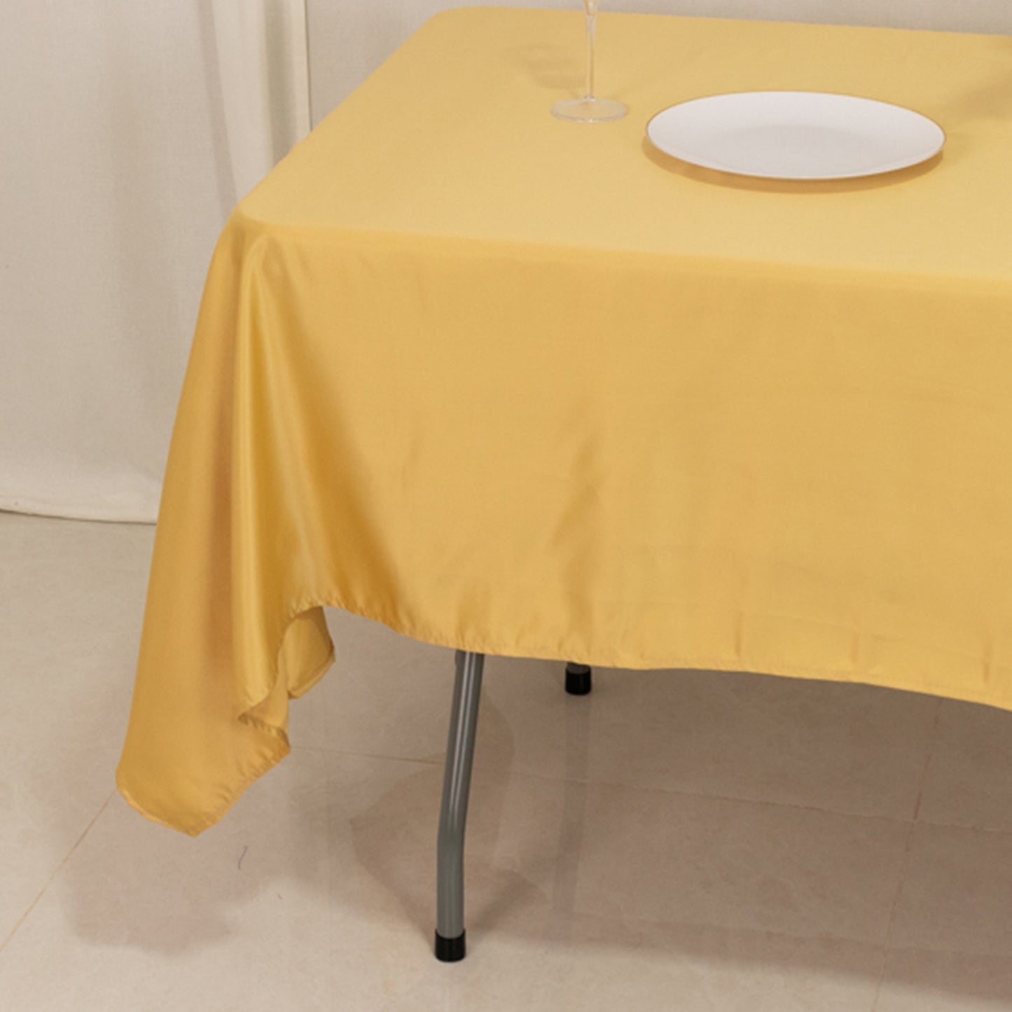 Champagne satin tablecloth on a dining table.