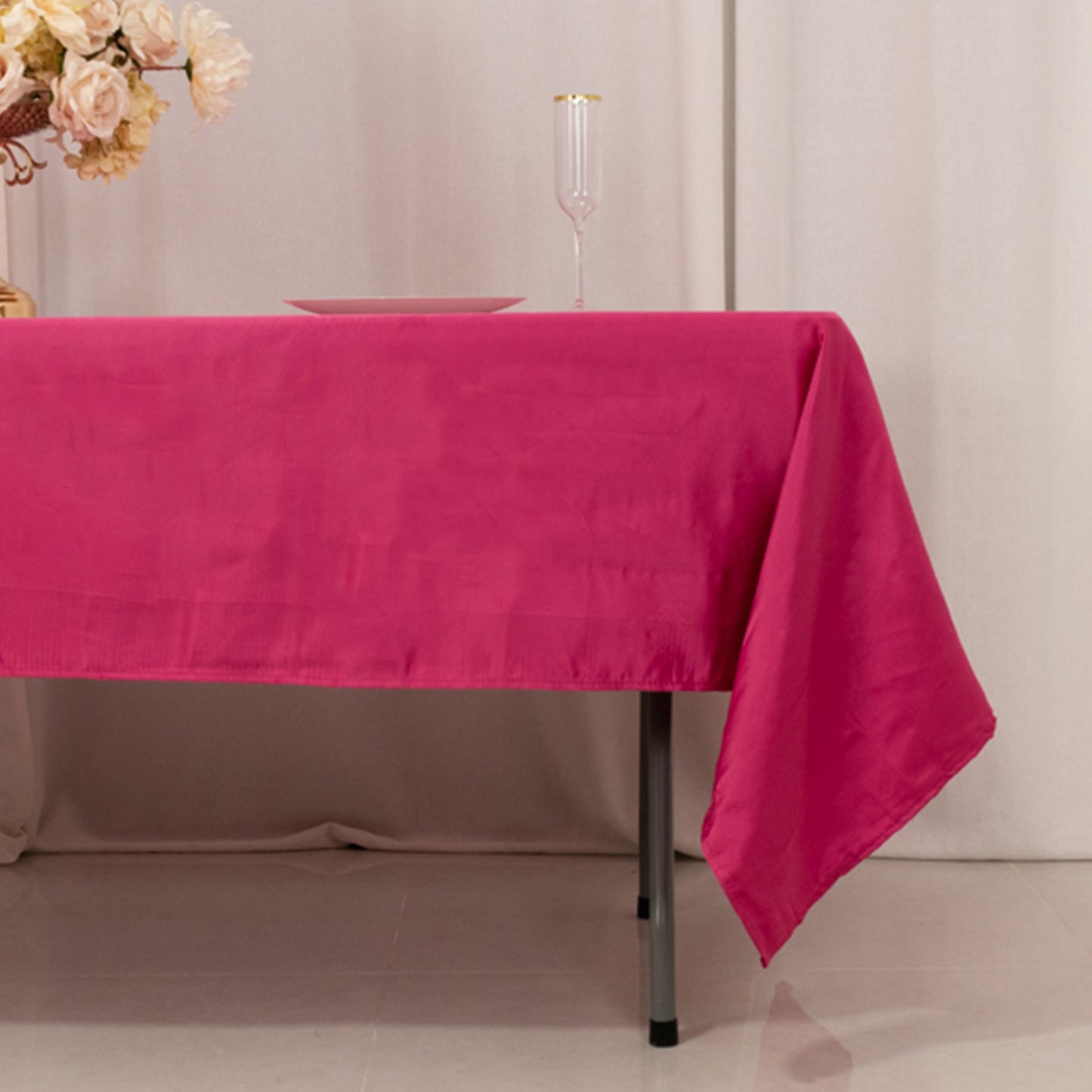 Fuchsia satin rectangle tablecloth on a dining table.