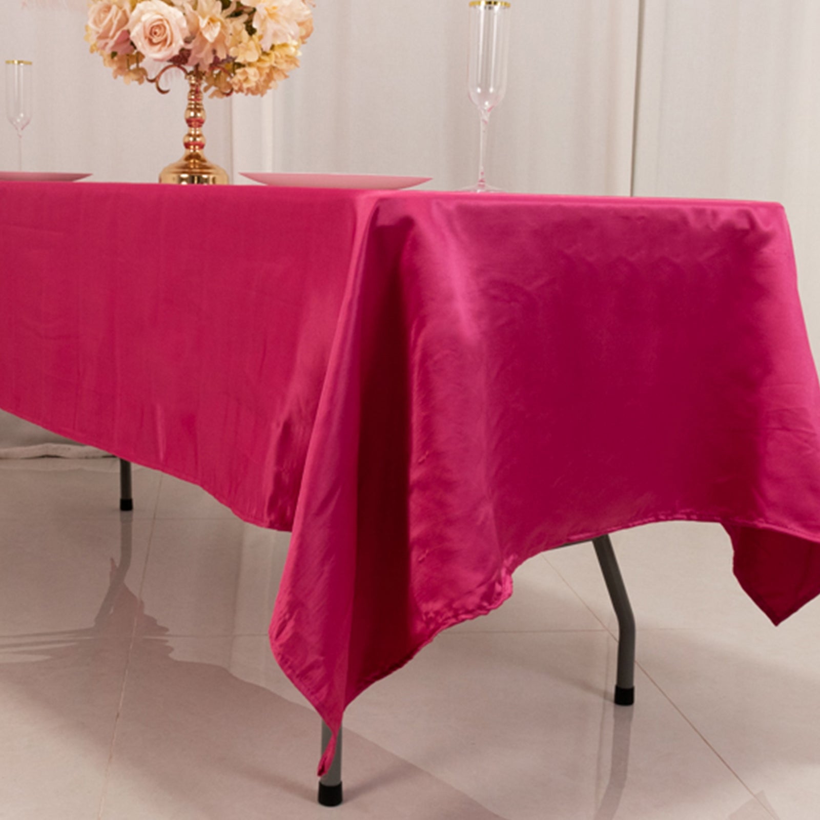 Fuchsia satin rectangle tablecloth on a dining table.