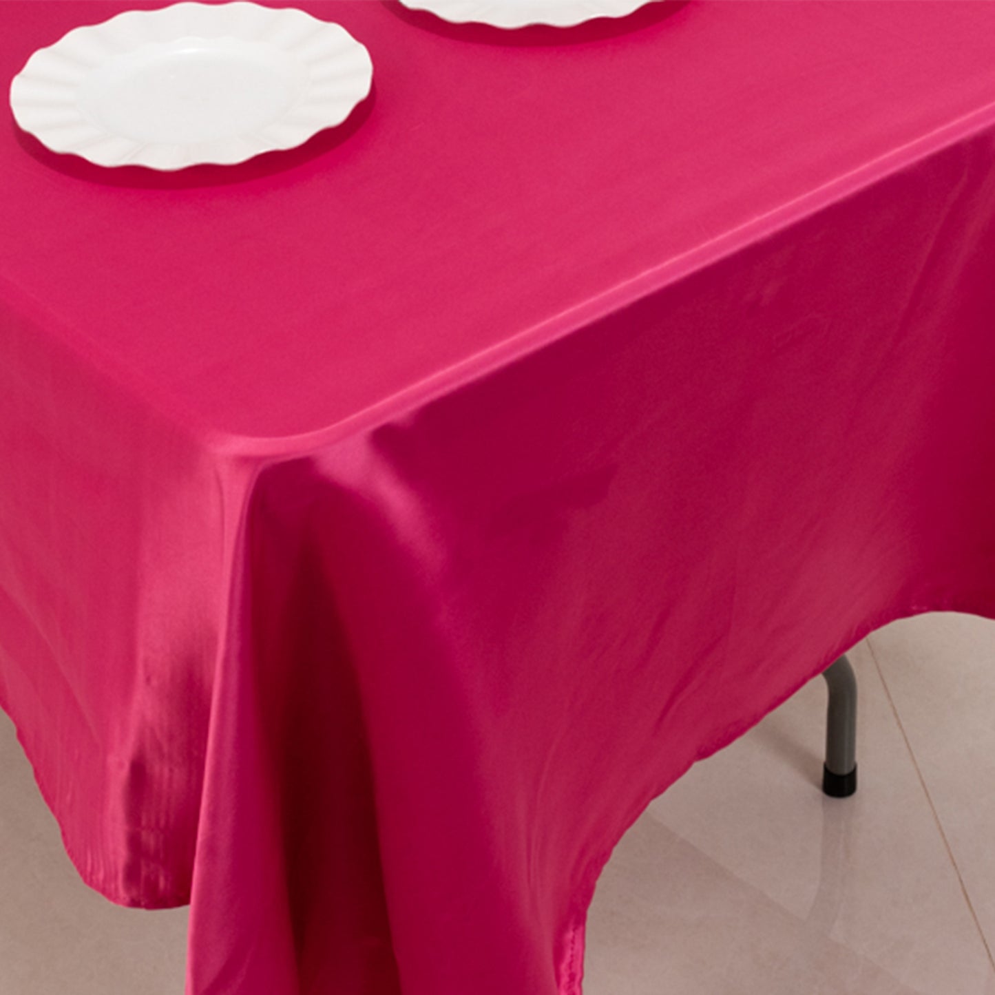 Fuchsia satin rectangle tablecloth on a dining table.