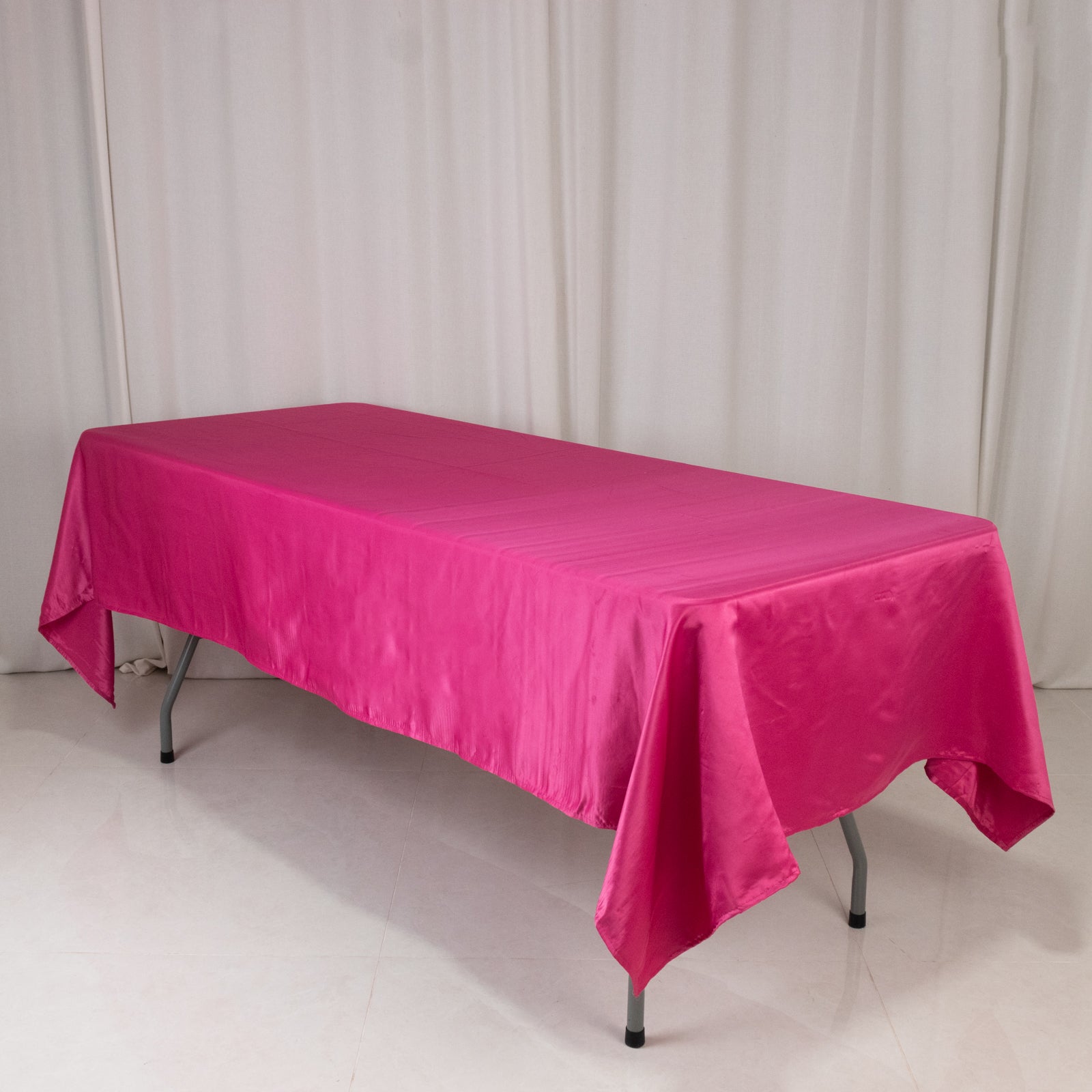 Fuchsia satin rectangle tablecloth for events and decor.