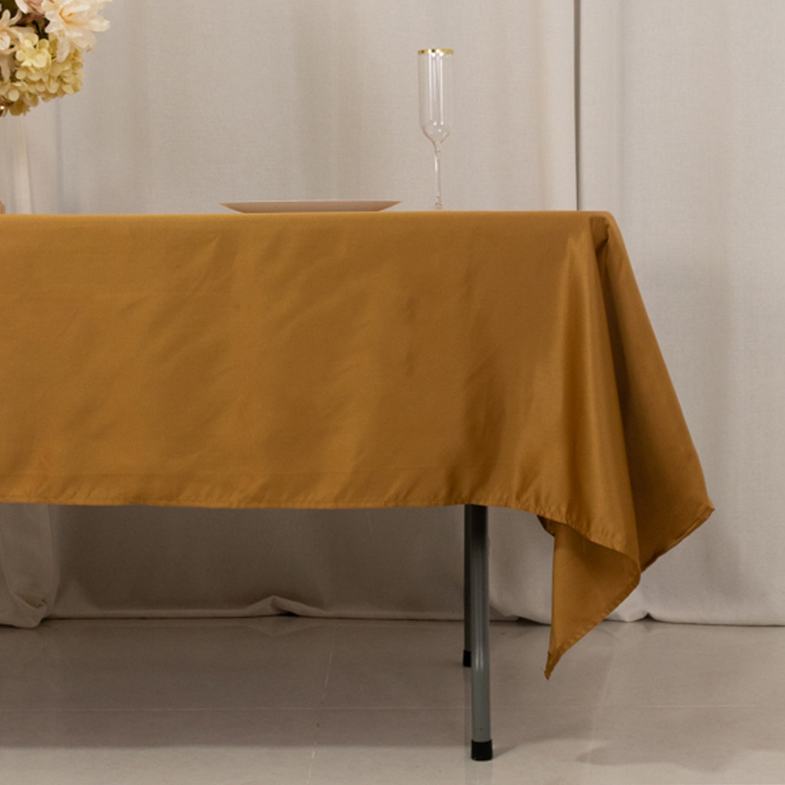 gold satin rectangle tablecloth on a table