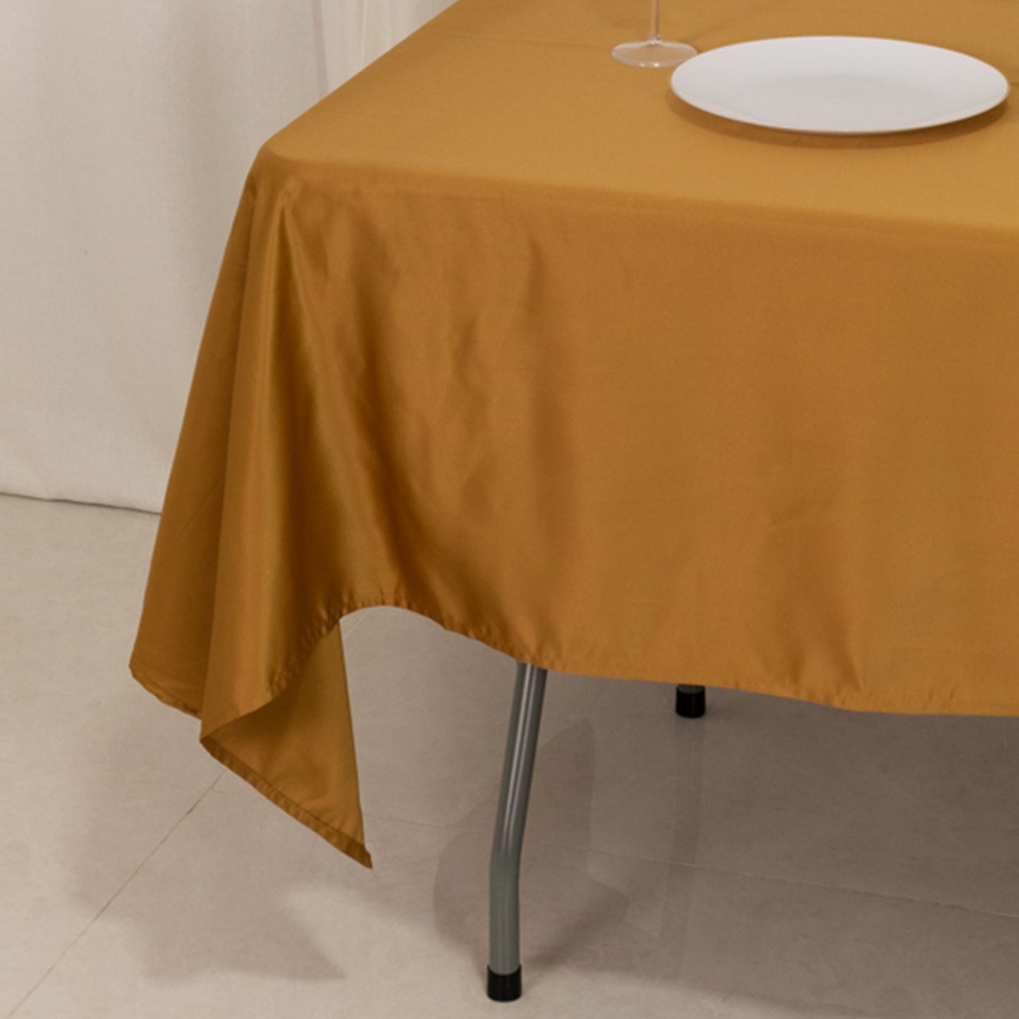 gold satin tablecloth on a rectangular table
