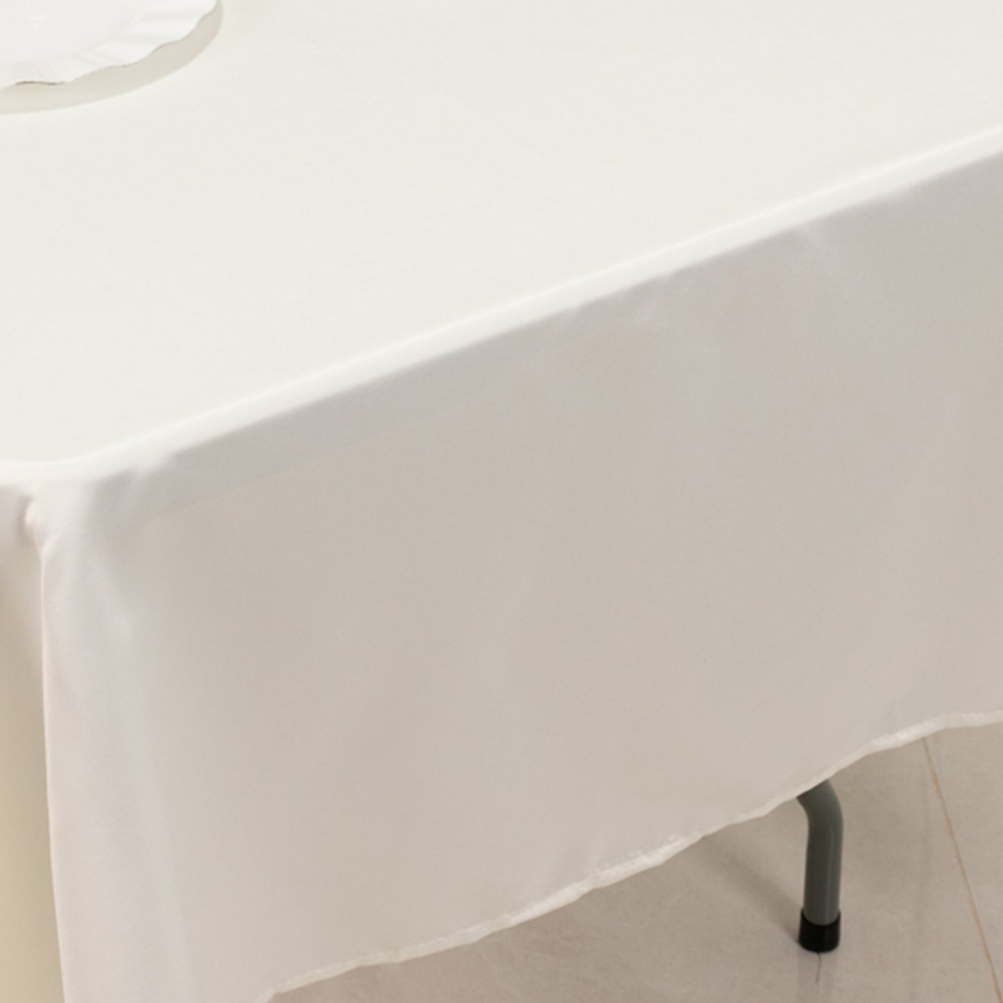 Ivory Lamour satin rectangle tablecloth on a table