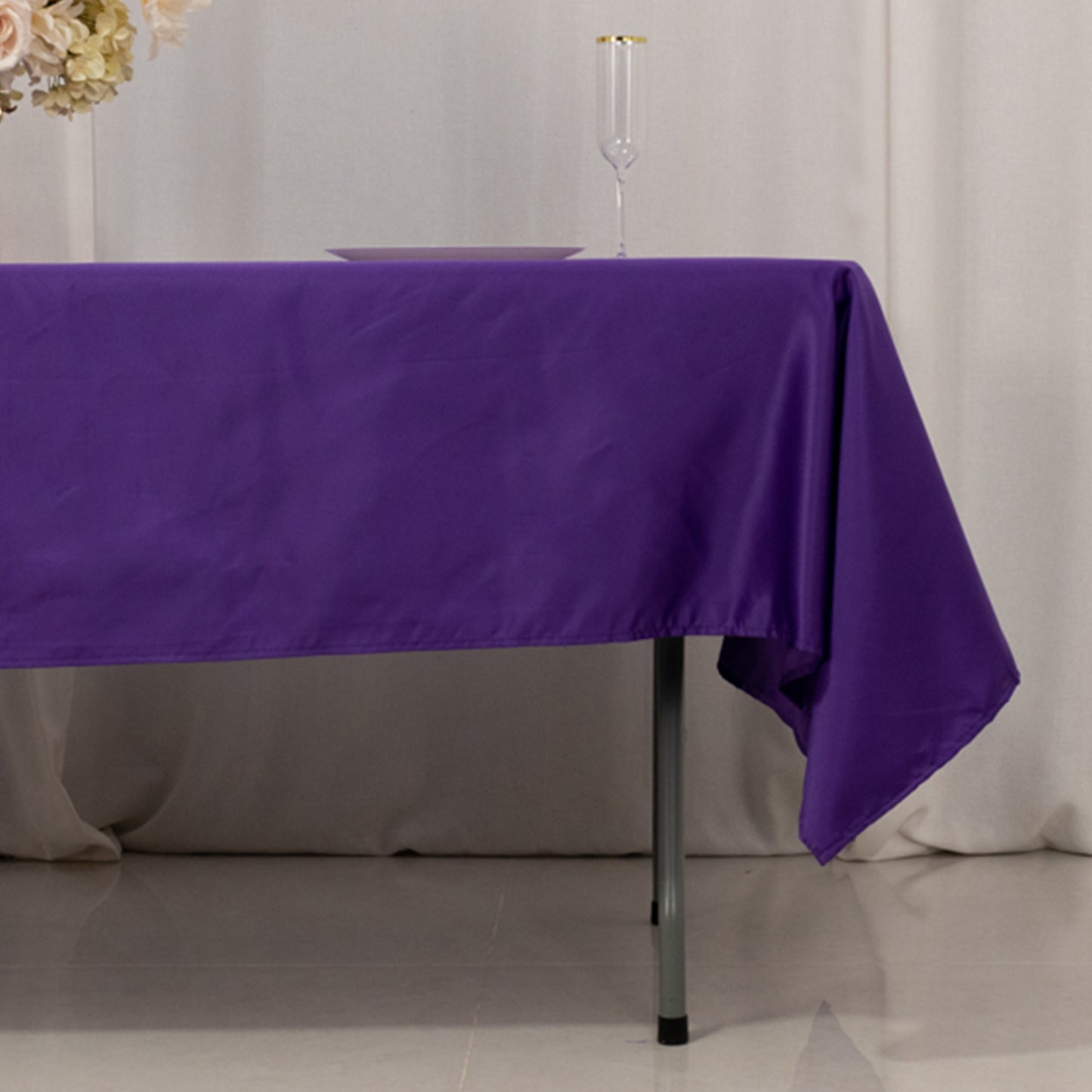 Purple satin rectangle tablecloth on a dining table.