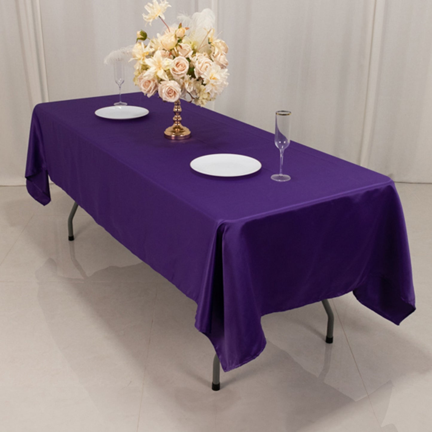 Purple satin rectangle tablecloth on a dining table.