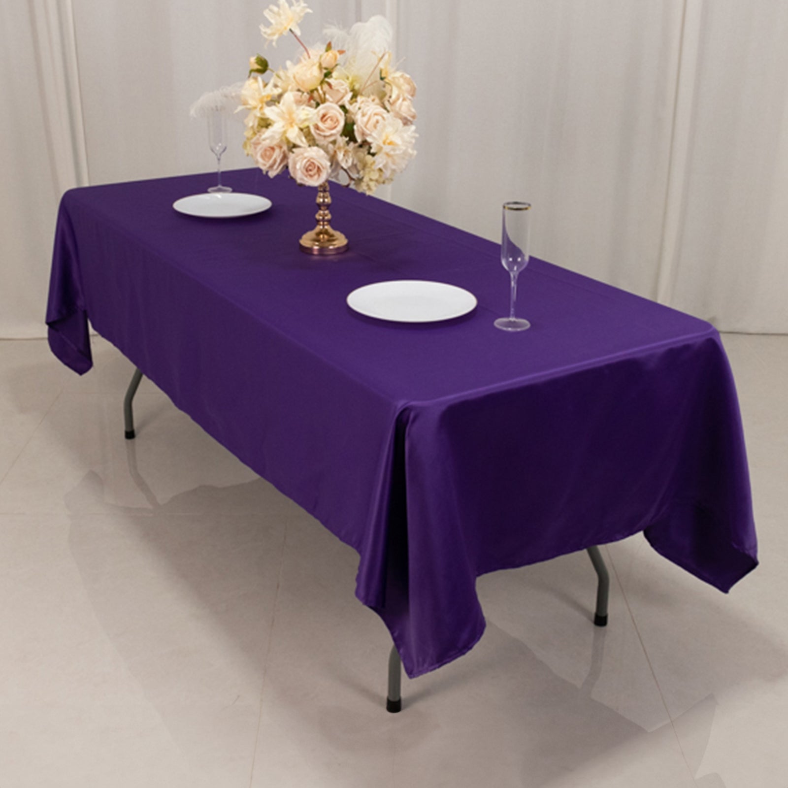 Purple satin rectangle tablecloth on a dining table.