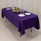 Purple satin rectangle tablecloth draped over a table with plates and glasses.
