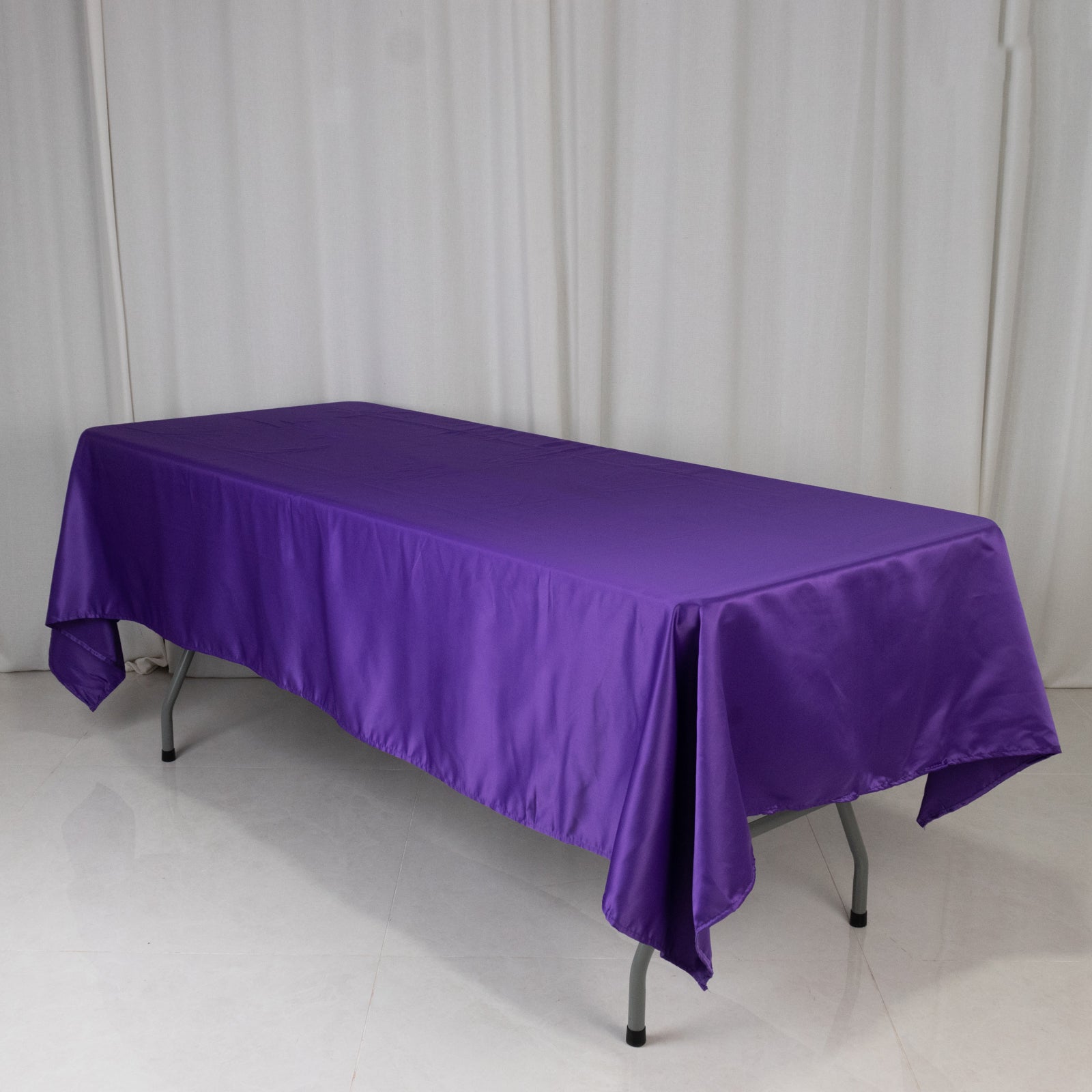 Purple satin tablecloth on a rectangular table.
