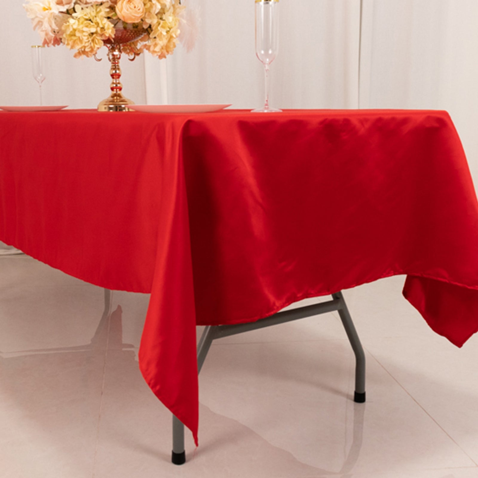 Red satin rectangle tablecloth on a table.