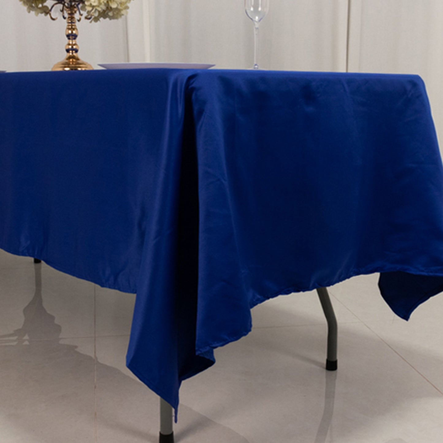 Royal blue satin rectangle tablecloth on a table.