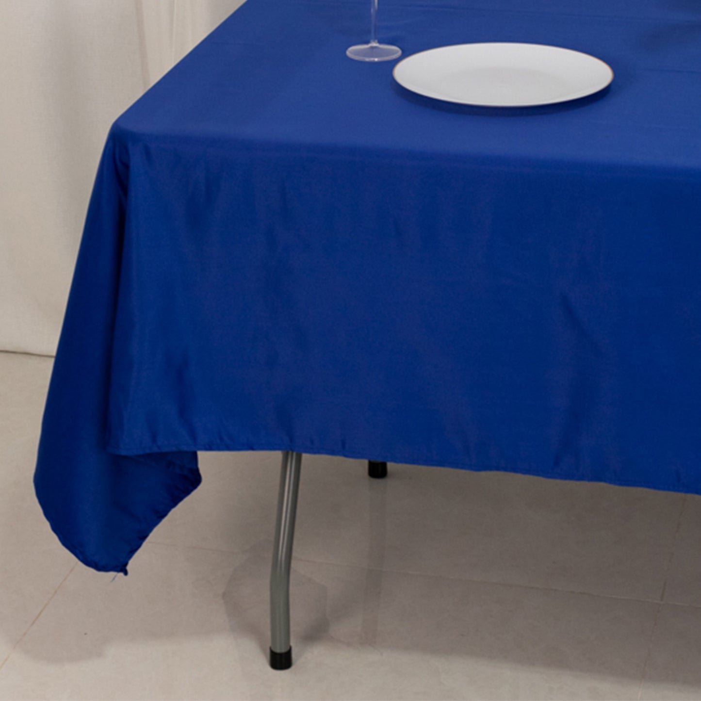 60"x102" Royal Blue Lamour Satin Rectangle Tablecloth on a table.